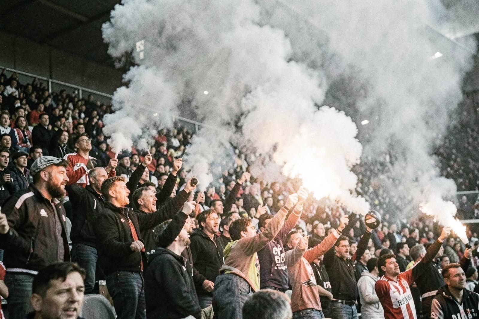 Supporters with flares in the stand